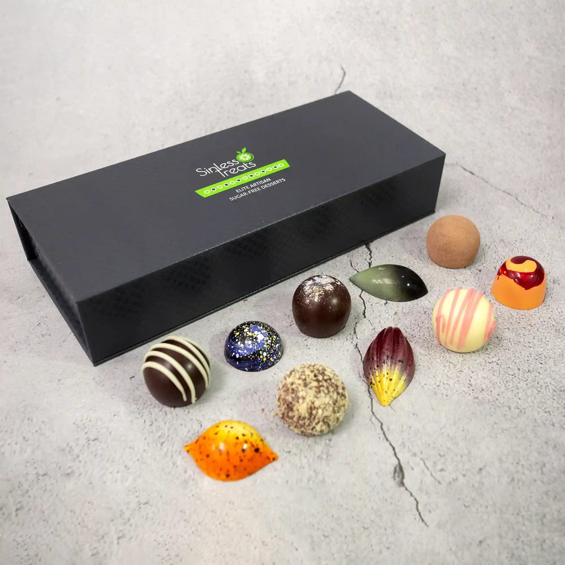 10 creamy and spiced truffles and chocolate bonbons part of Silk Road Luxury Box in front of a closed gift box