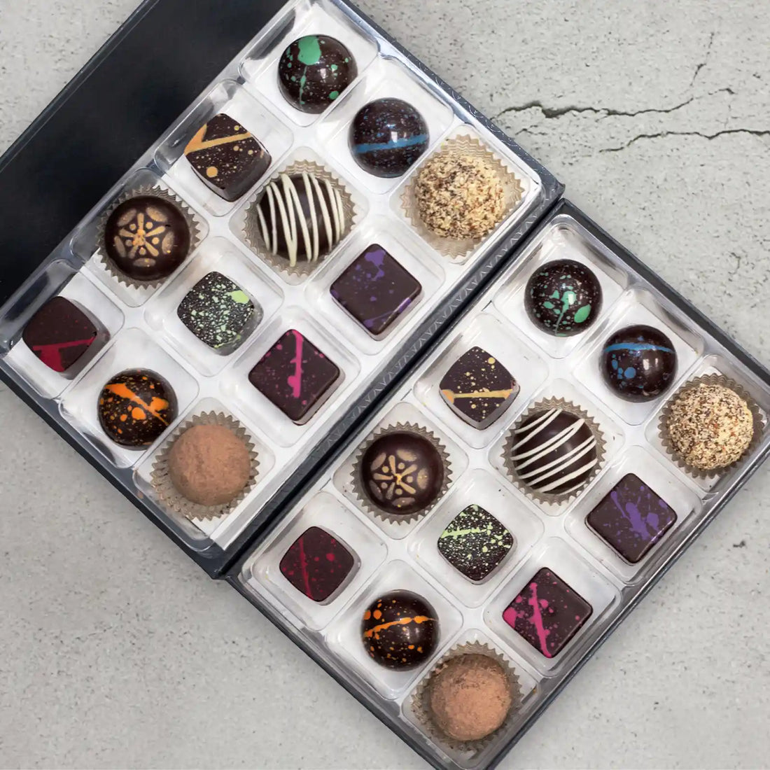 Cisele Elite 24-piece chocolate gift box showing the 12 flavors of sugar free dark chocolates with colored splattered paint and 4 truffles