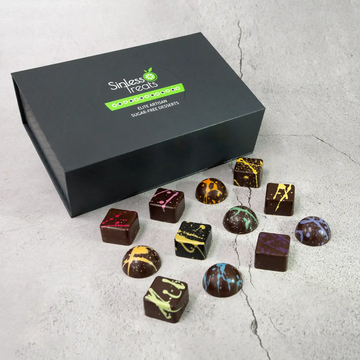 Miranda Elite 24-piece chocolate gift box showing the 12 flavors of sugar free dark chocolates with a rainbow of splattered paint