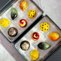 2 boxes of Fantasia Luxury Chocolate Box, each with 6 pieces of brightly painted citrus flavored chocolates