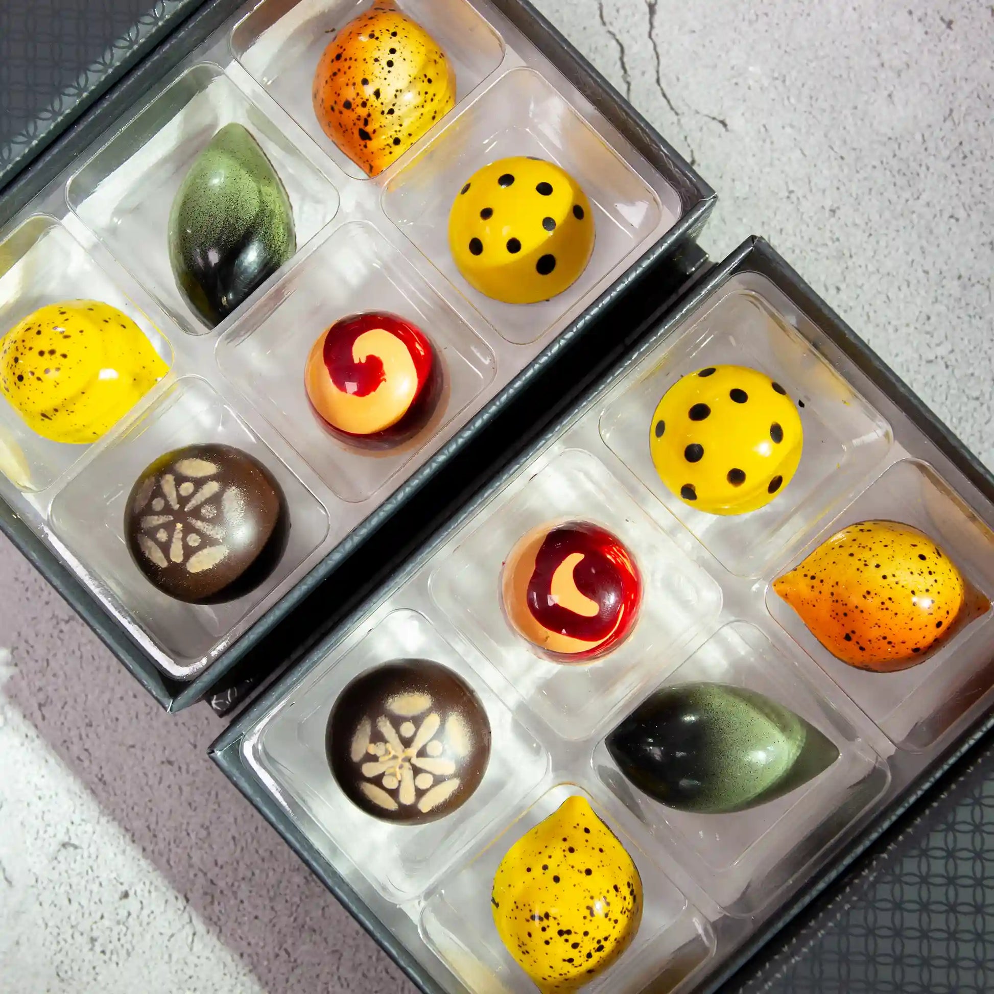 2 boxes of Fantasia Luxury Chocolate Box, each with 6 pieces of brightly painted citrus flavored chocolates