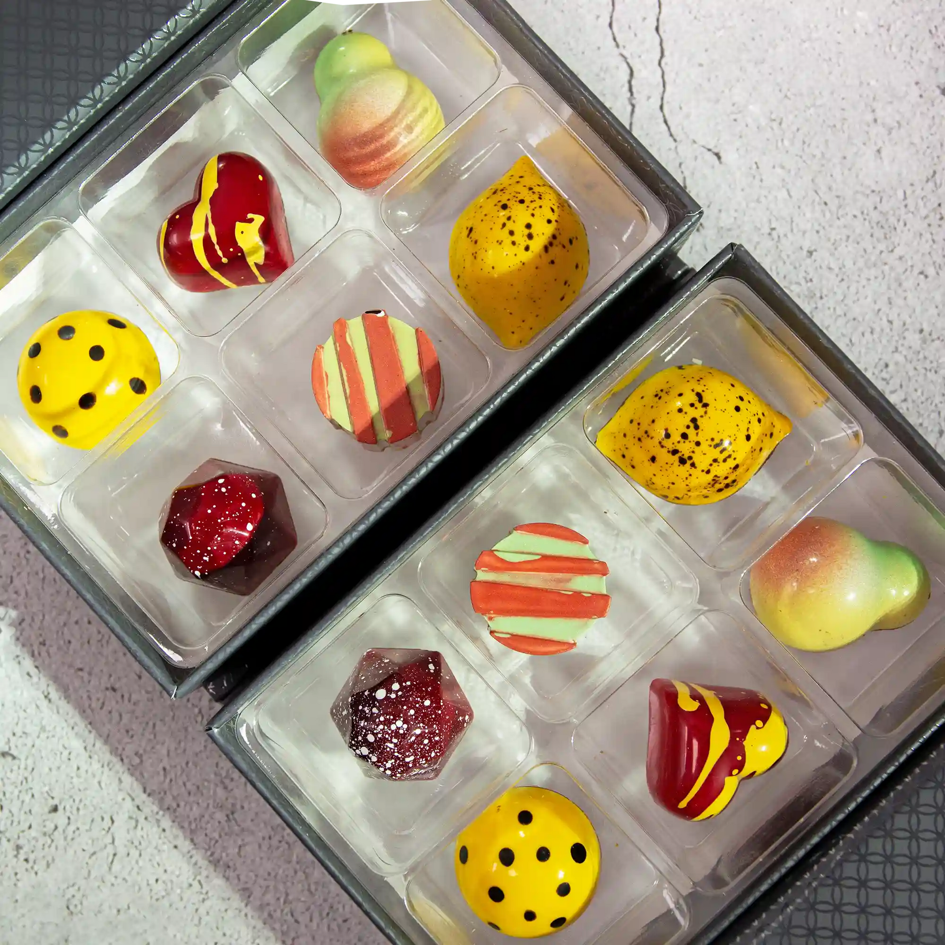 2 boxes of Vida Luxury Chocolate Box, each with 6 pieces of brightly painted fruity flavored chocolates