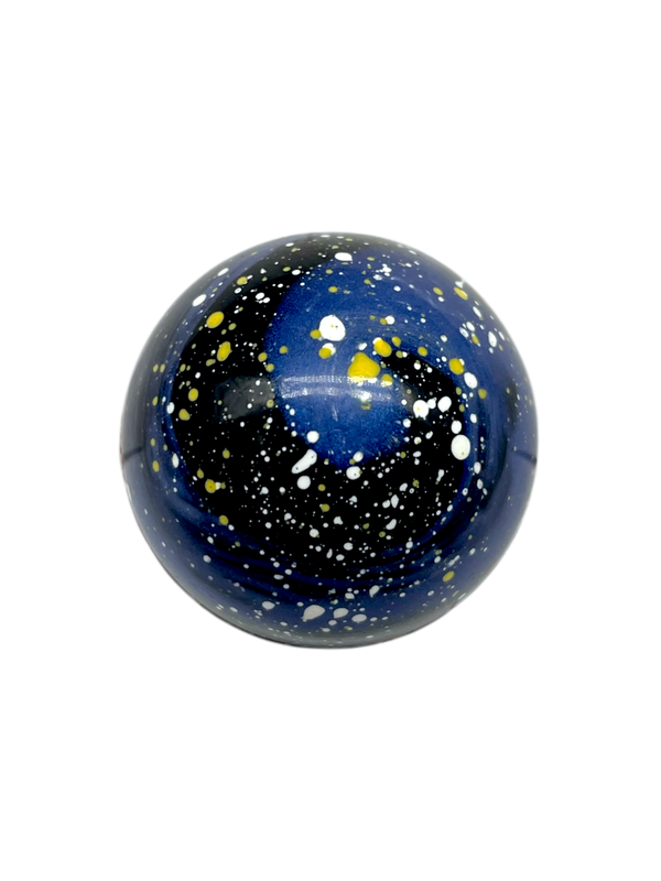 Cardamom Galaxy dome-shaped sugar free chocolate bonbon with blue and dark blue coloring and yellow speckles like stars in the sky