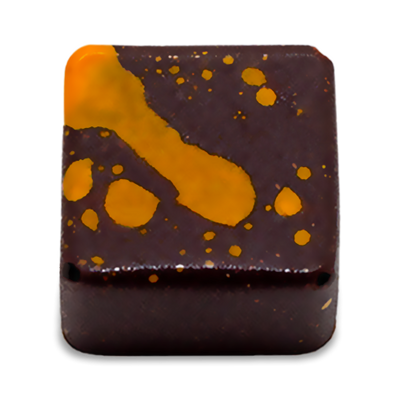 Fruity Caramel sugar free dark chocolate bonbon with orange splattered paint