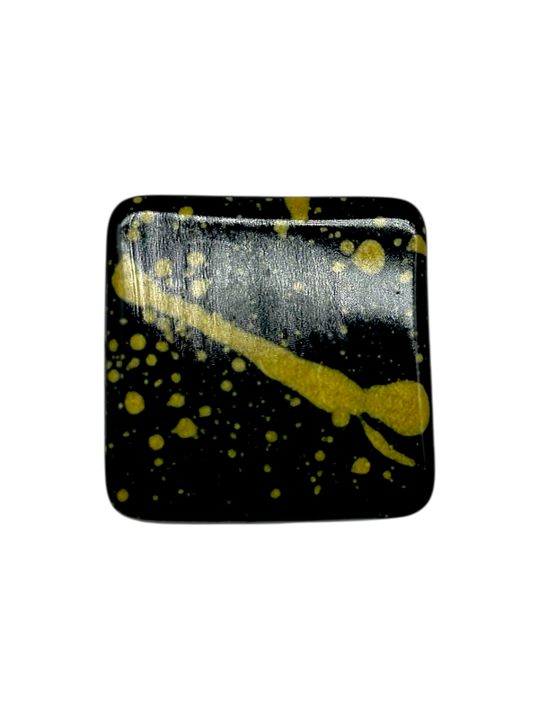 Irish Cream sugar free dark chocolate bonbon with orange splattered paint