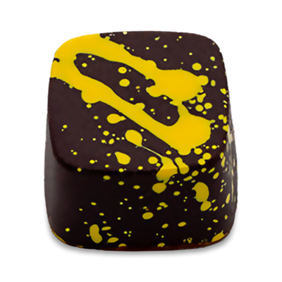 Lemon Curd dark chocolate bonbon with yellow splattered paint