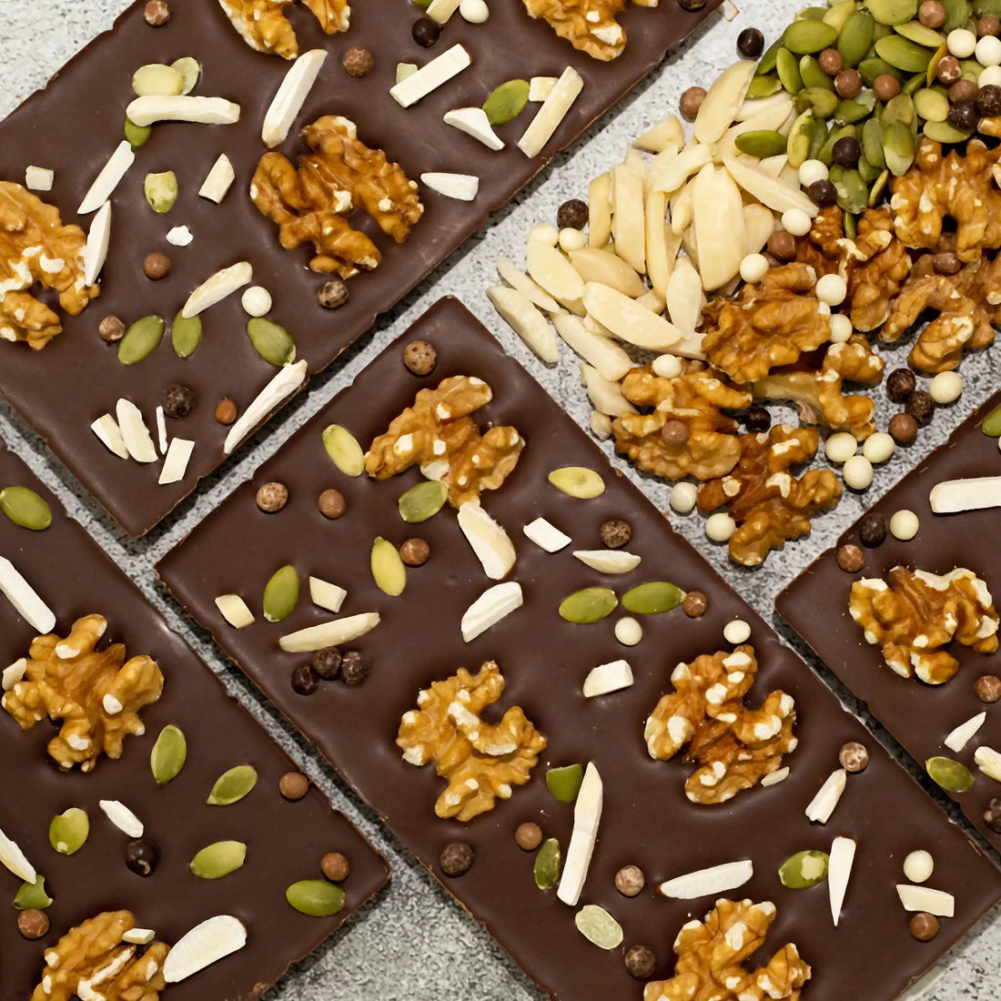 Symphony - Milk Chocolate Bar showing front hexagon pattern and back with walnuts, pumpkin seeds, and almonds