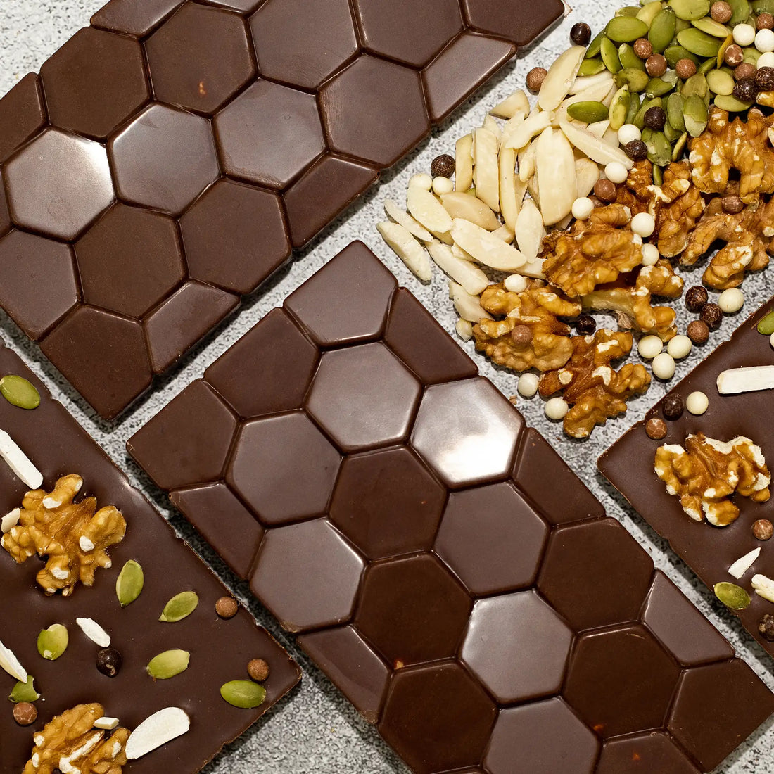 Symphony - Milk Chocolate Bar showing front hexagon pattern and back with walnuts, pumpkin seeds, and almonds