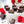 Molten Chocolate dark chocolate bonbon with red splattered paint and creamy ganache filling on a white table with red roses