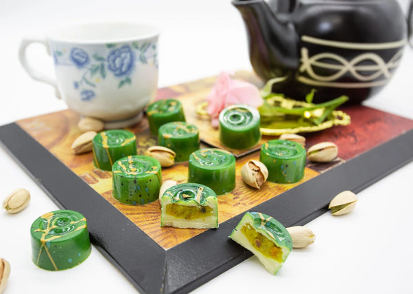 Pistachio Delight white chocolate bonbons with green coloring and sea salt caramel filling