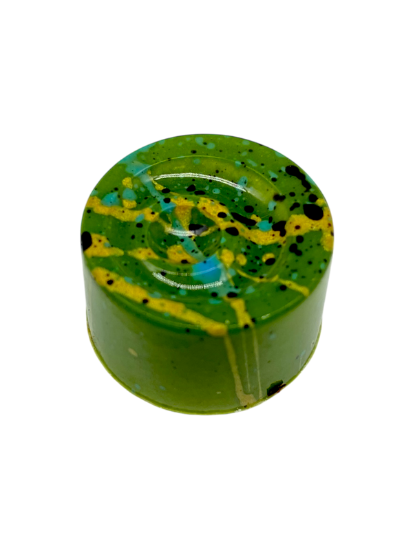 Pistachio Delight sugar free white chocolate bonbon with green coloring and splatters of orange and blue