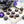 Spicy Earl Grey dark chocolate bonbons with blue splattered paint sitting beside teapot and cup of tea surrounded by flowers