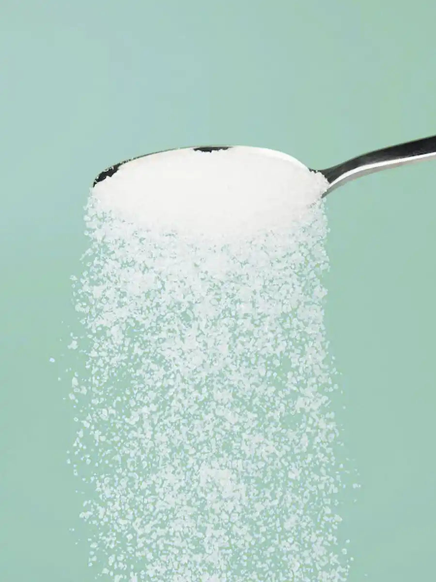 Allulose sugar substitute spilling off of a spoon