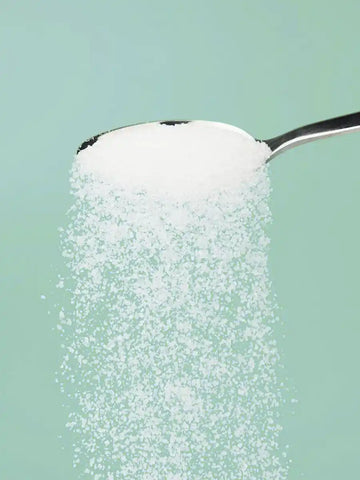 Allulose sugar substitute spilling off of a spoon