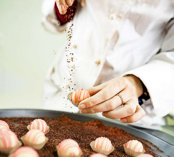 Beata sprinkling dried raspberries on white chocolate Indulgence Truffle