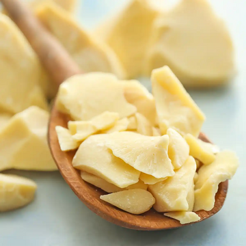 Cacao butter on a wooden spoon