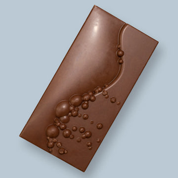 Milk Chocolate Bar on a light blue background