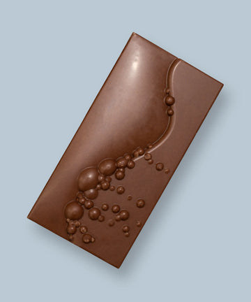 Milk Chocolate Bar on a light blue background