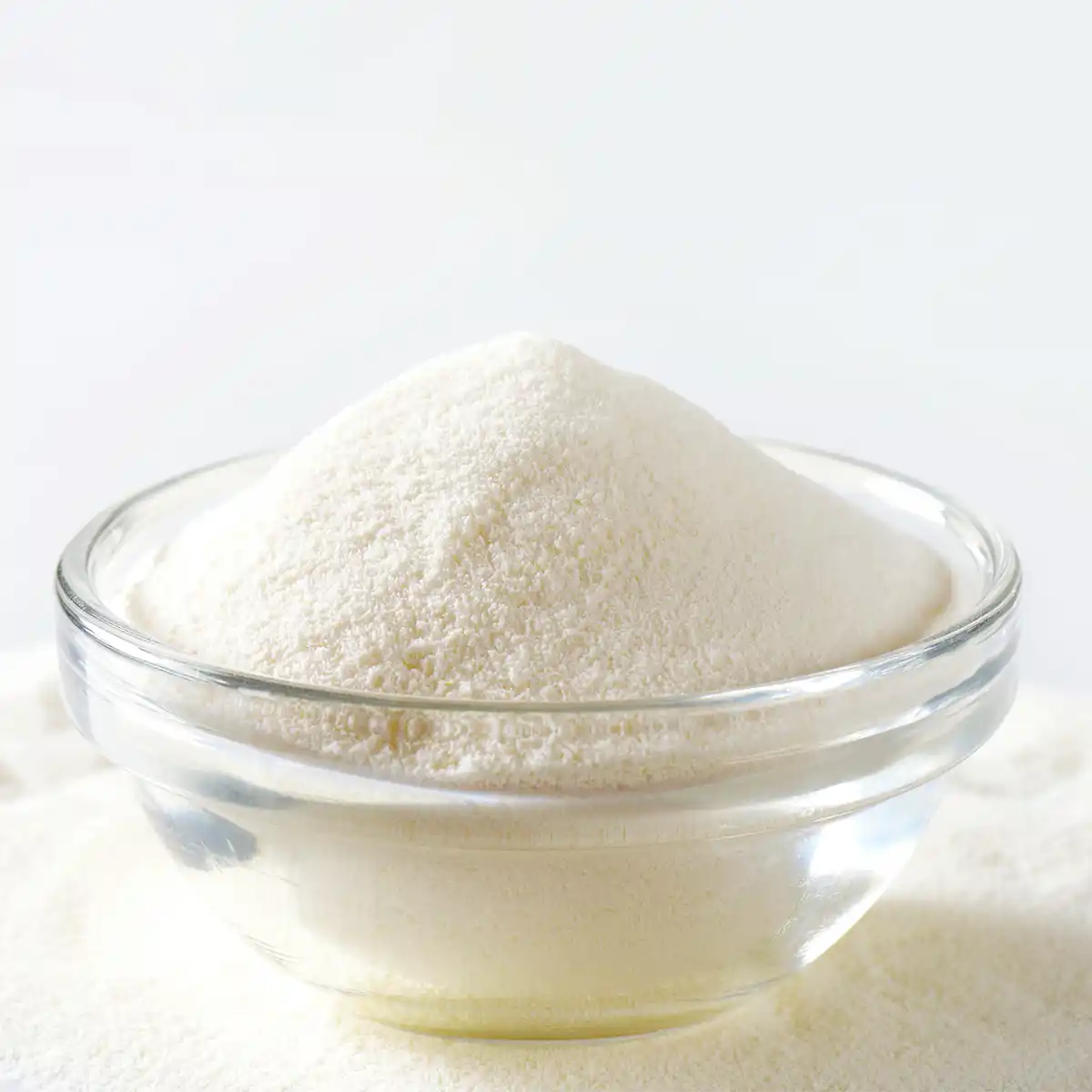 Organic milk powder in a clear small bowl